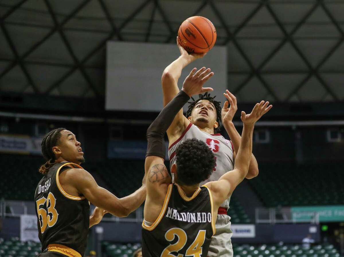 Stanford’s Spencer Jones, who had 15 points, shoots over Wyoming’s Hunter Maldonado during the Cardinal’s win in the first round of the Diamondhead Classic in Honolulu.
