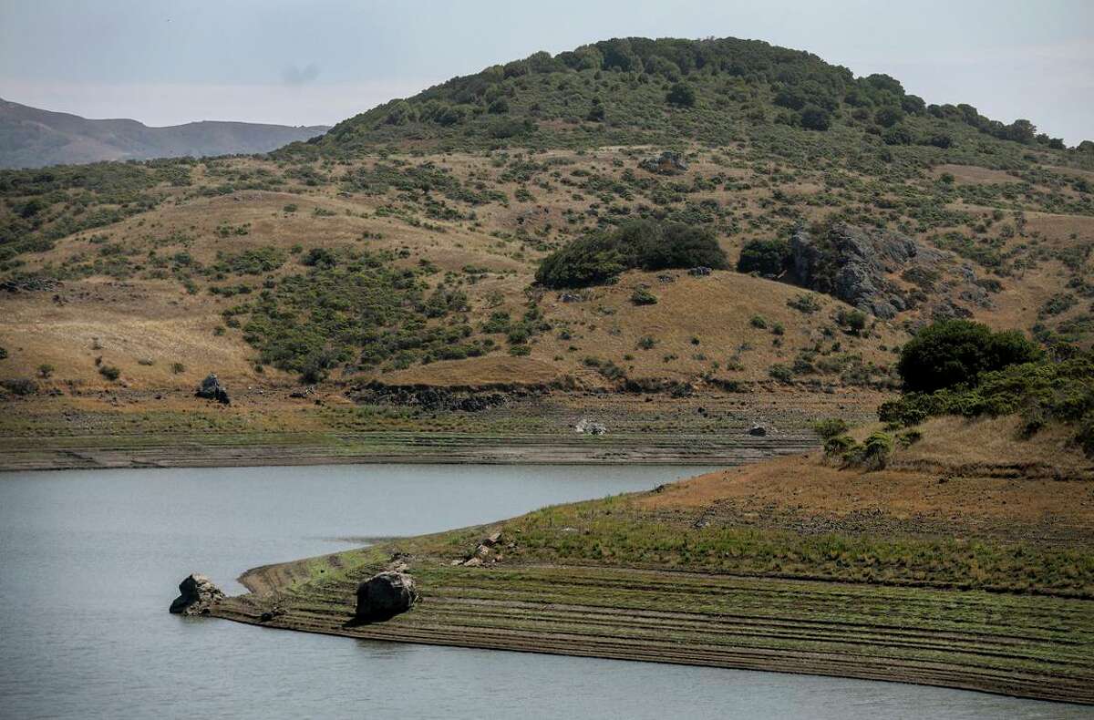 The low level in July at the Nicasio Reservoir in Marin County is evident. The state’s biggest reservoirs have hit historic lows during the drought.