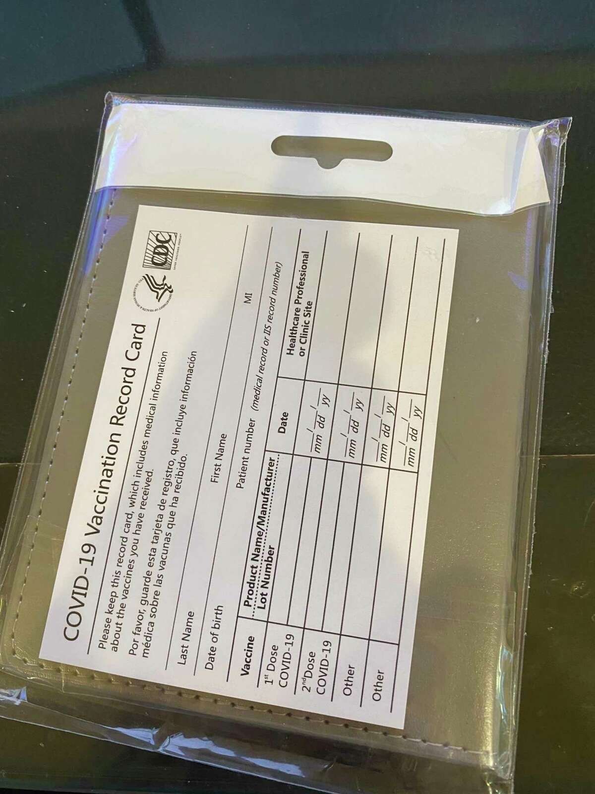 A fake COVID-19 vaccination card a Stamford, Conn. resident said he received along with the passport holder he ordered off of Amazon.