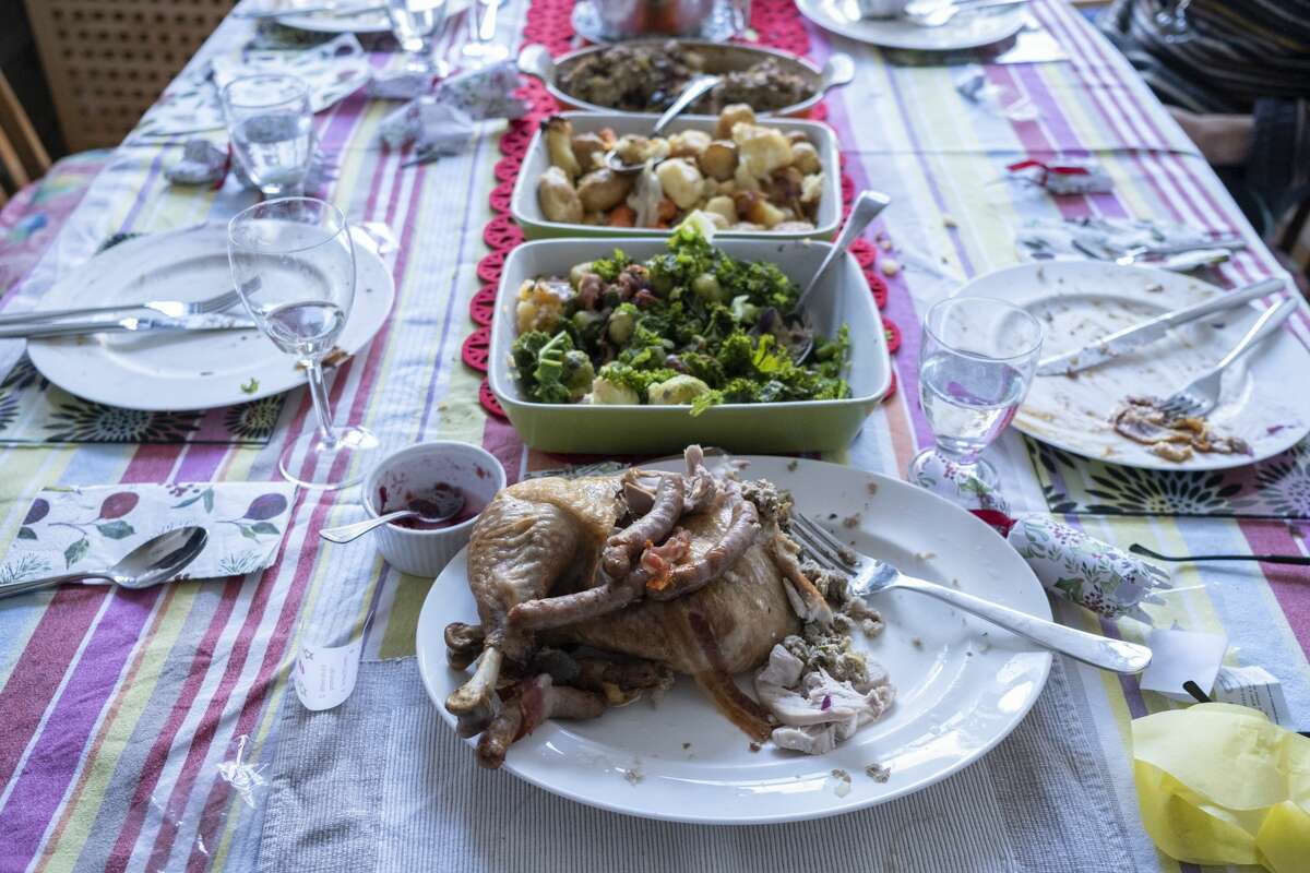 Remnants of a Christmas dinner lay on a table in London, England. Health officials urge people to refrigerate or freeze perishable foods and leftovers within two hours and discard any cooked or perishable foods left at room temperature for longer than two hours. (Photo by Richard Baker / In Pictures via Getty Images)