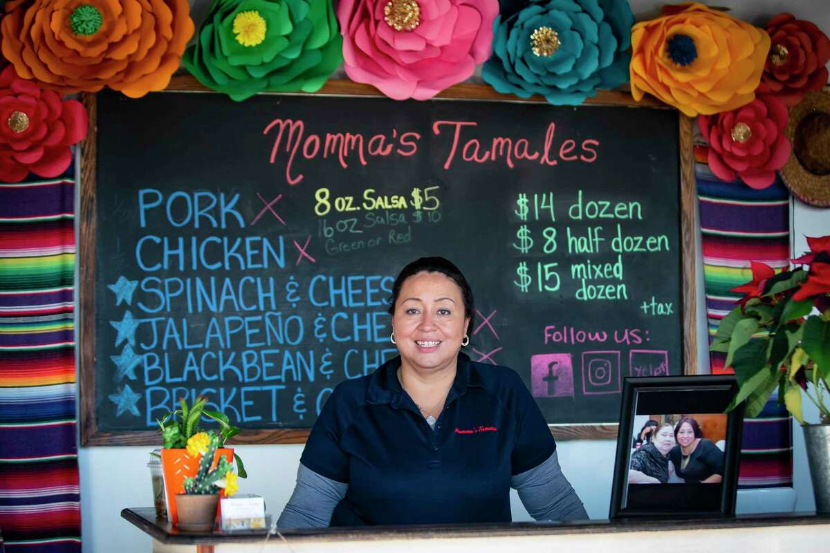 Ana Soria stands at the front of the storefront she opened last year to sell Momma’s Tamales, Wednesday, Dec. 22, 2021, in Bellaire. After the death of her mother, Leonor Arenas, who was a prolific maker of tamales, Soria found herself cooking more and more tamales and eventually selling them at farmer’s markets. During the pandemic, Soria opened the storefront with its own kitchen in Bellaire.