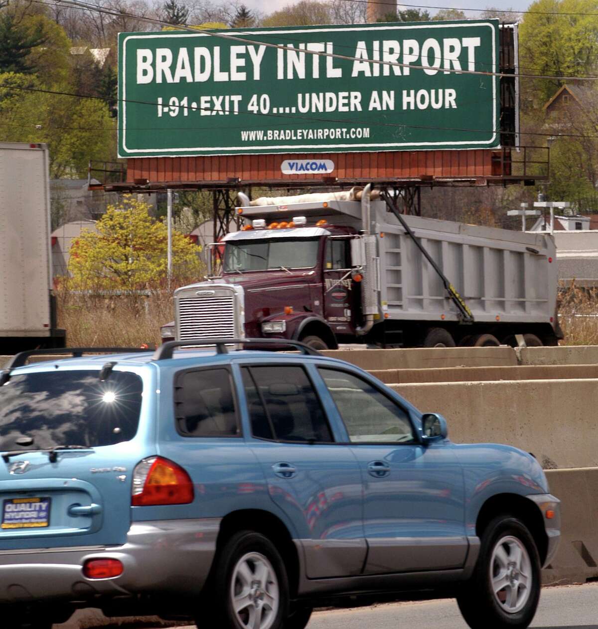 A sign along I-95 near the New Haven /East Haven line, states that Bradley International Airport can be reached in less than 1 hour.