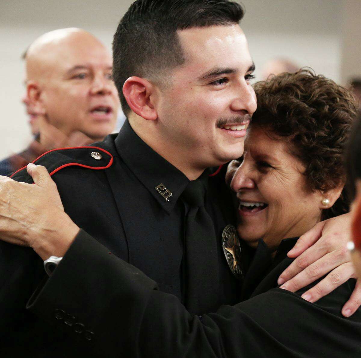Xavier Leal hugs his grandmother, Pauline Bustamante, Dec. 14 during the 117th Alvin Community College Law Enforcement Academy graduation. Leal was named Top Gun for the highest achievement in firearms training.