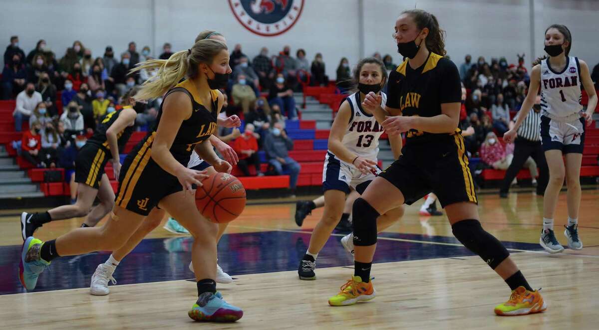 The Law girls team brings the ball up court against Foran in the second game of a doubleheader between the city rivals.
