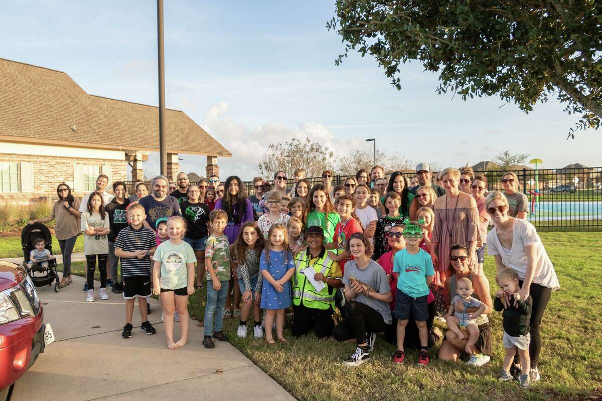Hidden Lakes neighborhood families gather for a photo with Clear Creek Independent School District crossing guard Lillian Closs Dec. 16 after presenting her with a $3,500 gift for the holidays.