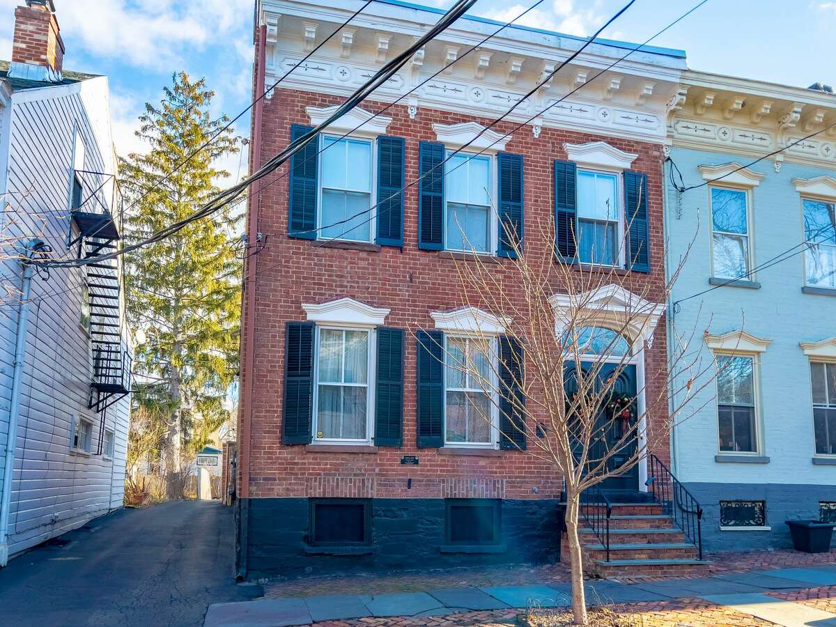 The final selection of 2021 is 19 Washington Ave., Schenectady, a brick row house in the Stockade. Originally built in 1827, it was made over in a Victorian style in the 1870s, when an entry foyer and the parquet floors were installed on the first floor. The original beams are visible in the basement, where the current owners built a bar. The house has three bedrooms and two and a half baths, and includes a guest suite on the third floor. There are beautiful finishes throughout the house and a large, modern kitchen. The property has a private brick courtyard and two-car garage. It is above the flood plain. Schenectady schools. Taxes: $7,691. List price: $449,900. Contact listing agent David Schwartz of Field Realty at 518-369-1359 for a showing. 