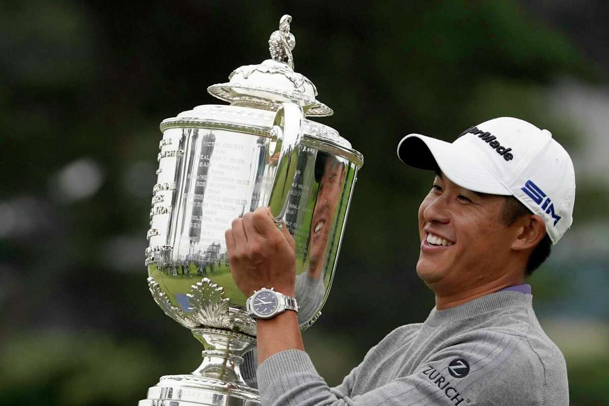 Collin Morikawa holds the Wanamaker Trophy after winning the PGA Championship golf tournament at TPC Harding Park Sunday, Aug. 9, 2020, in San Francisco. (AP Photo/Charlie Riedel)