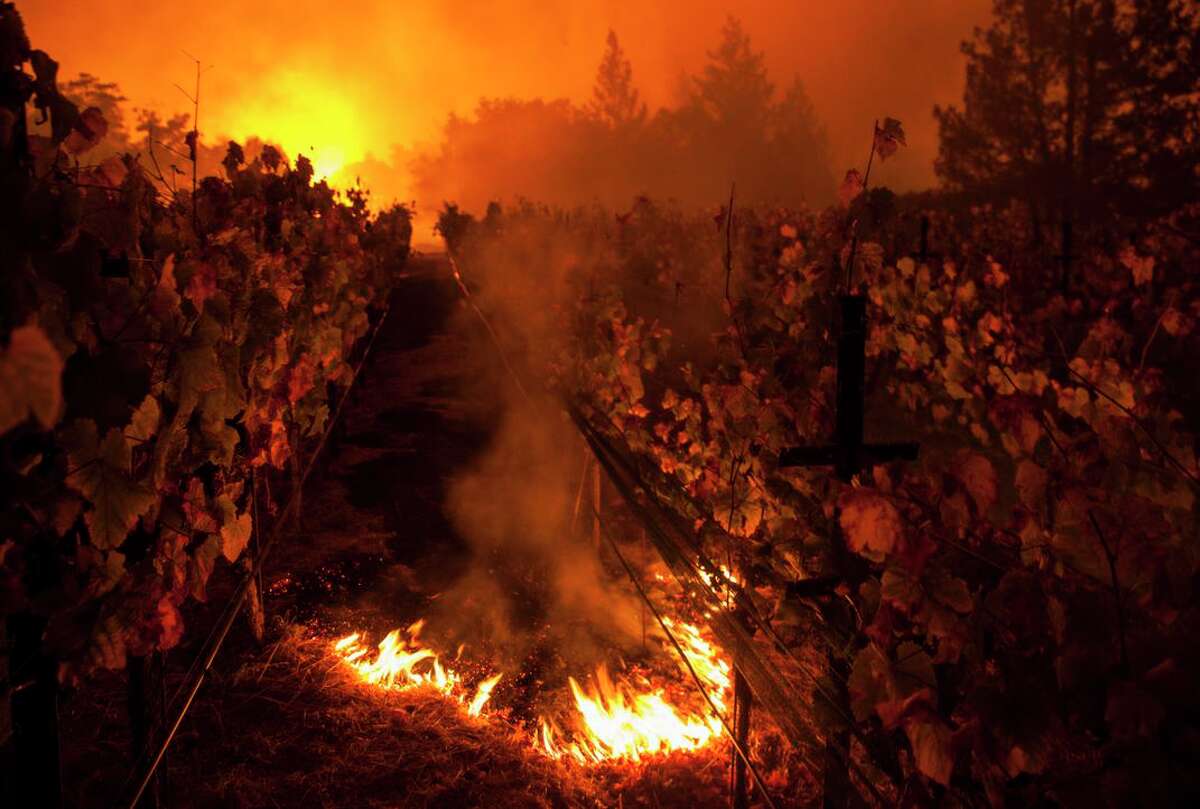 Fire burns at Paras Vineyards as the main structure on the property burns in the background during the Nuns Fire west of downtown Napa in October 2017.