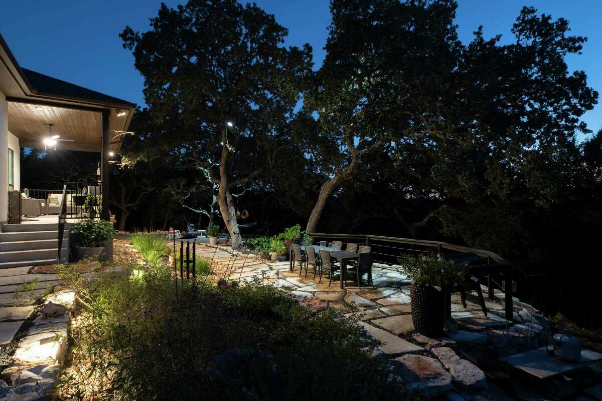 Mood lighting installed in the large live oak trees that surround the backyard casts a soft, enchanting glow over everything.