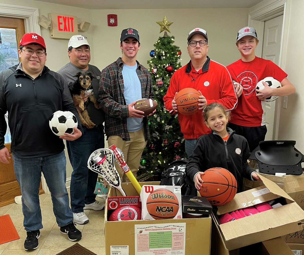 Ridgefield High School juniors Will Hanna and Justin Keller organized a sports equipment drive to benefit families served by the Saint Joseph Parenting Center in Stamford. Pictured is Hanna, center, with the Rosenfield and Yuen families.
