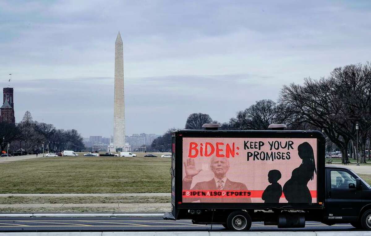 A truck displaying messages expressing concern over the mass deportations of Black immigrants drives past the Washington Monument in February.