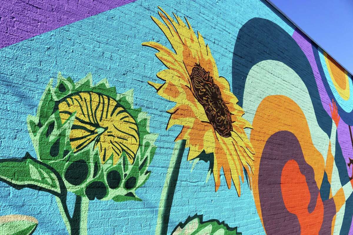 A sunflower brightens up a section of the mural.
