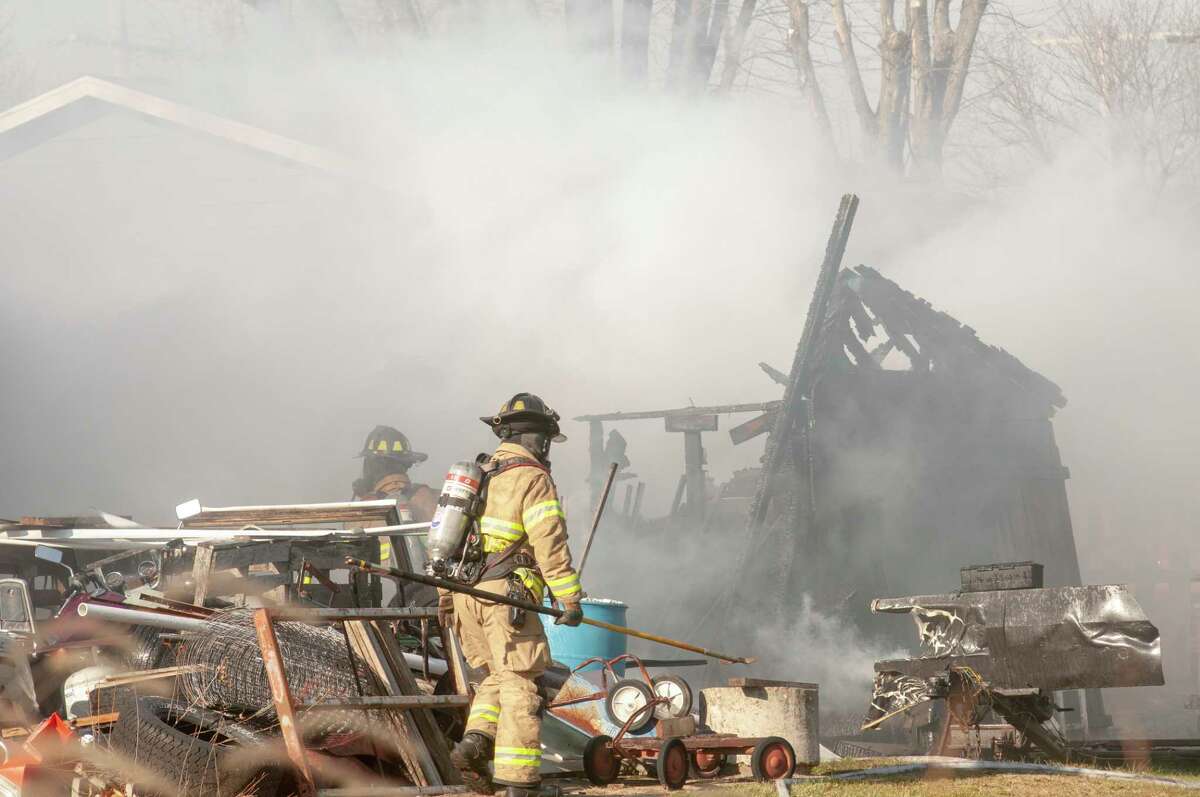 Jacksonville and South Jacksonville fire departments battle a shed fire Thursday that spread to the main house in the 400 block of Pine Street. No injuries were reported. 