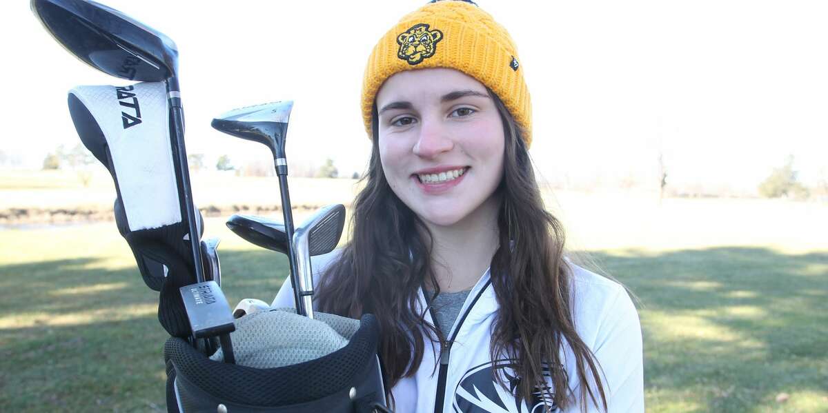 Routt's Addie Dobson holds a set of clubs her Grandma Sharon gave her for Christmas five years ago. The gift began an odyssey that culminated with a scholarship to play golf at the University of Missouri.