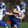 Action from No. 3 Darien’s 24-10 win over No. 2 New Canaan in the CIAC Class LL high school football semifinal on Dec. 5.