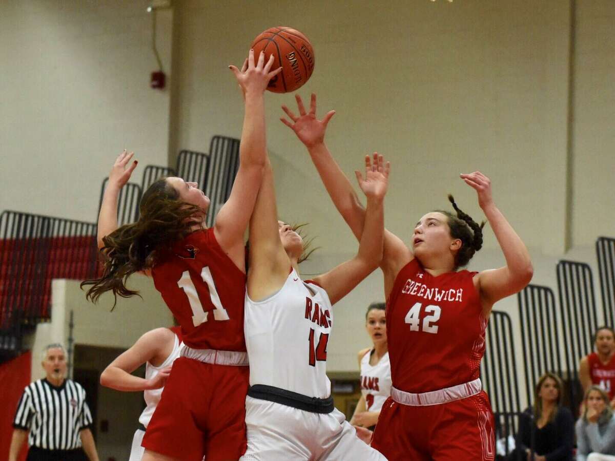 Greenwich’s Kayla Anderson (42) and Kristin Riggs (11), and New Canaan’s Kearney McKiernan (15) go up for a rebound during a game at New Canaan High in 2020.