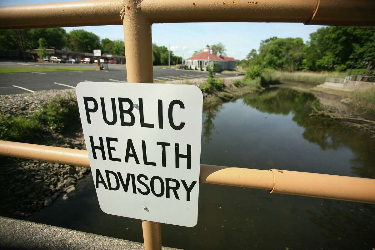 A public health advisory sign near Ferry Creek in Stratford, where much of Raymark's toxic materials was dumped and never cleaned up.