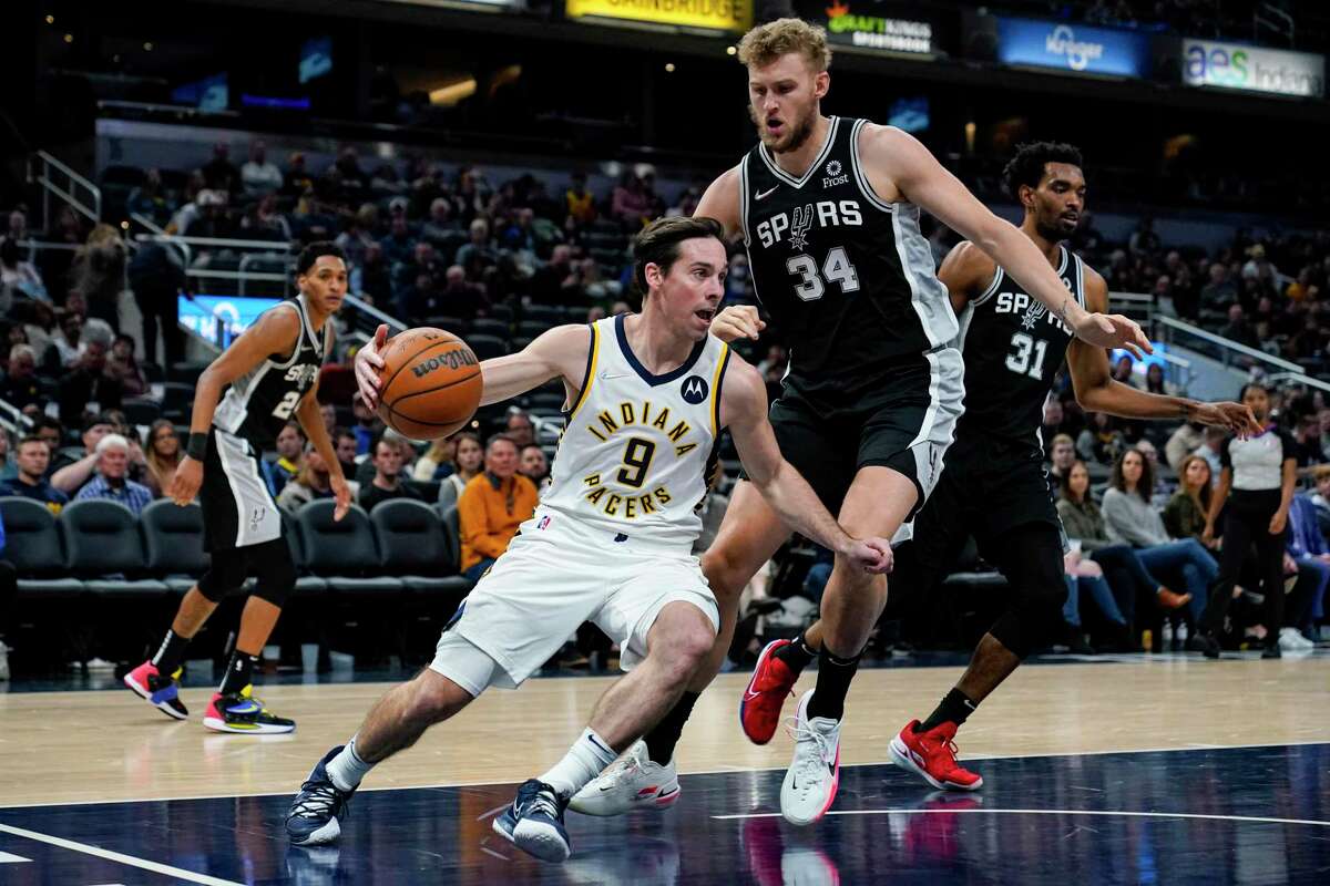 Indiana Pacers guard T.J. McConnell (9) drives under San Antonio Spurs center Jock Landale (34) during the second half of an NBA basketball game in Indianapolis, Monday, Nov. 1, 2021. The Pacers defeated the Spurs, 131-118.