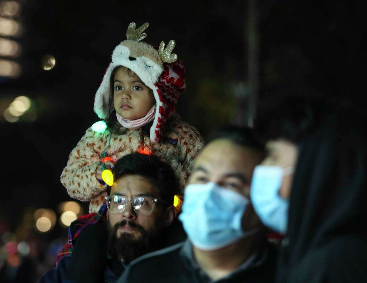 Ione Alcantar, 3, on her dad, Jose’s shoulders as they waited in line for food during the 33rd Annual Uptown Holiday Lighting, Thursday, Nov. 25, 2021 in Houston. The evening will culminate with a dazzling tree light show and fireworks extravaganza, illuminating Houston from the sidewalks to the sky.