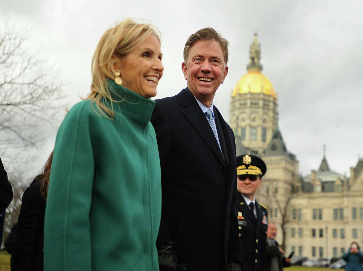 Flanked by daughter Lindsay, left, and wife Annie, newly sworn in Governor Ned Lamont marches in a parade past the Capitol in Hartford, Conn. on Wednesday, January 9, 2019.