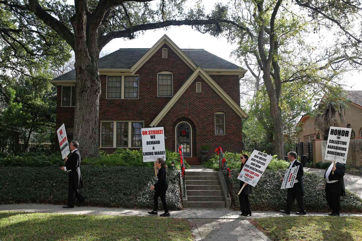 Members of the San Antonio Symphony demonstrate outside the Monte Vista home of San Antonio Symphony Board Chair Kathleen Weir on Thursday, December 23, 2021. Musicians urge board and management to negotiate contract fair. The musicians have been on strike since the end of September.