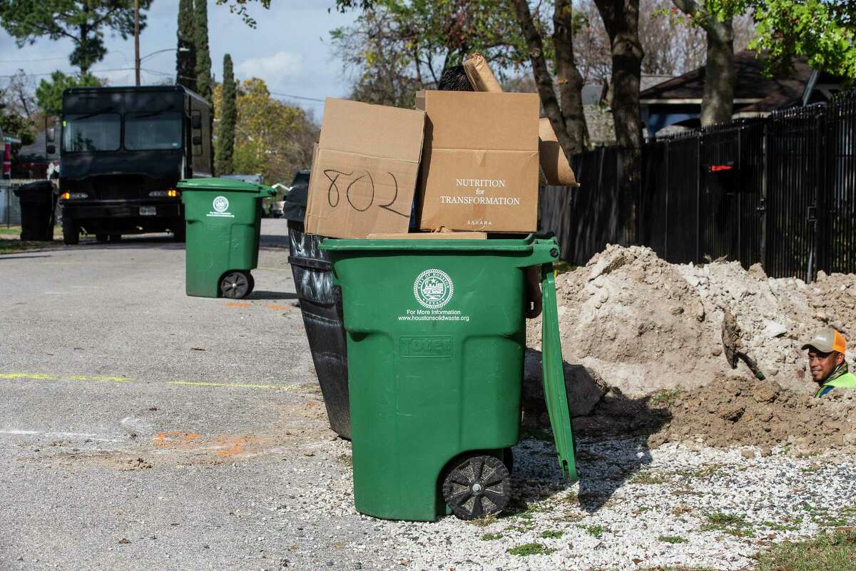 Recycling bins line the street set out to be picked up in the Heights Thursday, Dec. 16, 2021 in Houston. The Heights leads the city in 311 reports for the ninth consecutive year in a row. The top report is missed recycling pick-ups, a quality shared only by Montrose.