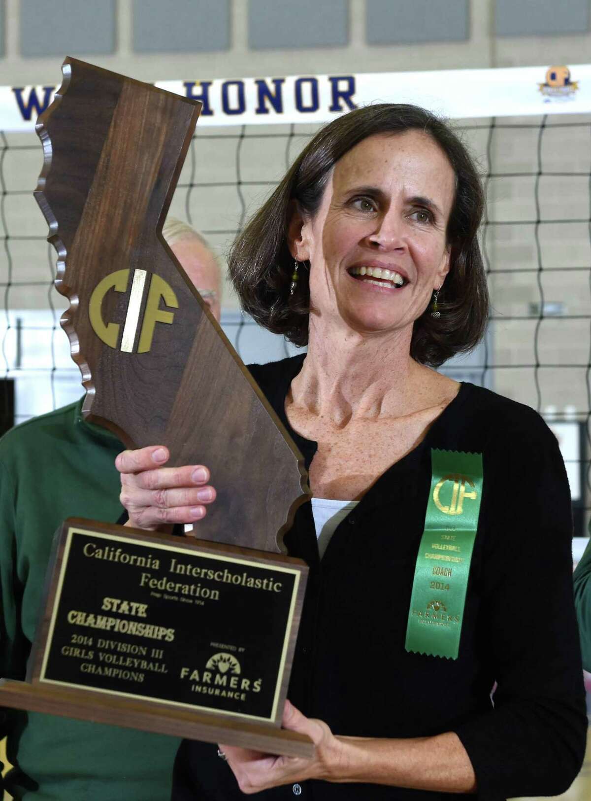 Margi Beima holds the trophy after her Sacred Heart Cathedral girls volleyball team won the 2014 state Division 3 championship, finishing the season 37-3.