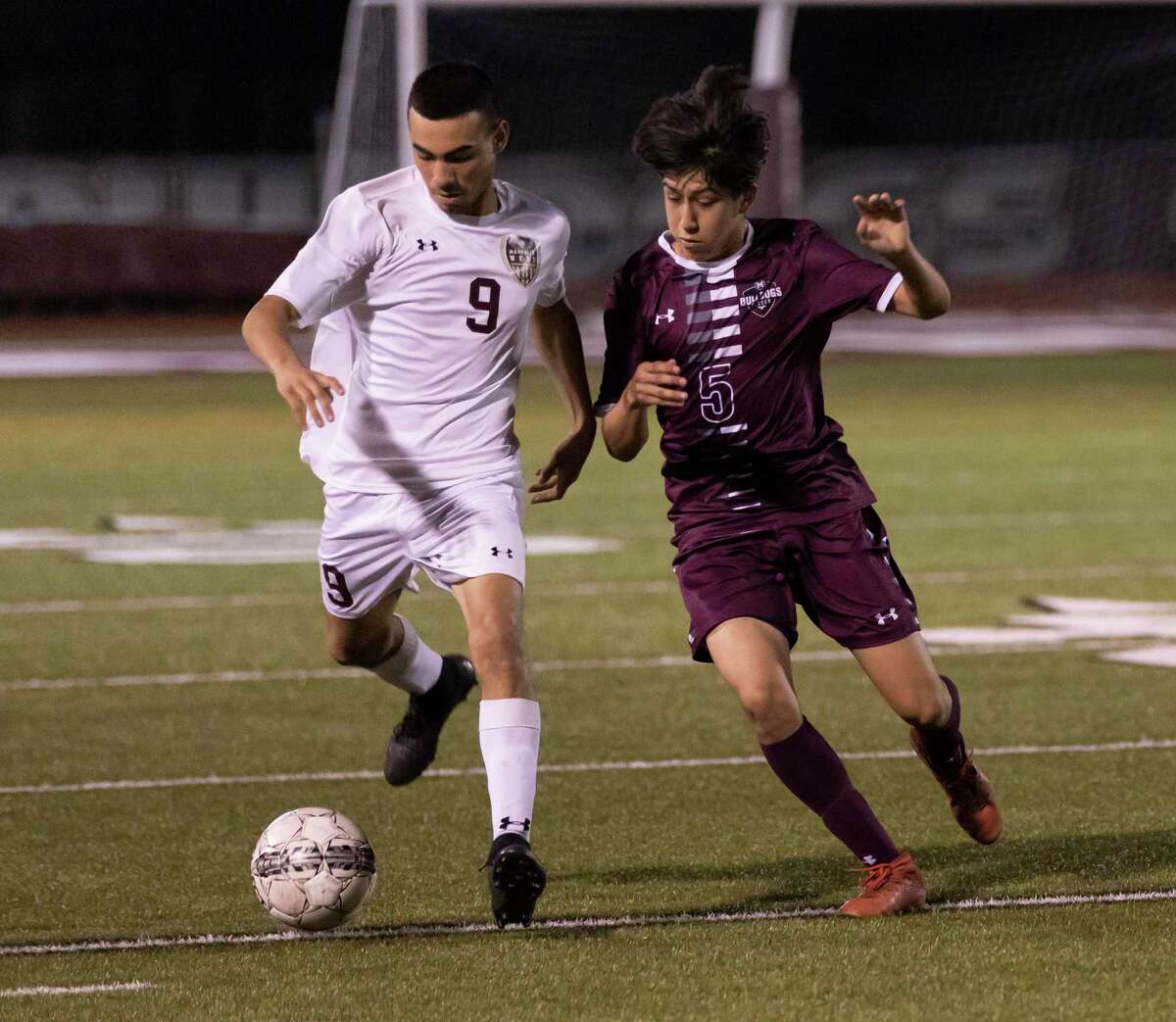 Abel Piedra of Magnolia (5) and Magnolia West defender Jose Moreno (9) fight for control of the ball during the first half in a District 19-5A boys soccer game on Tuesday, March 3, 2020.