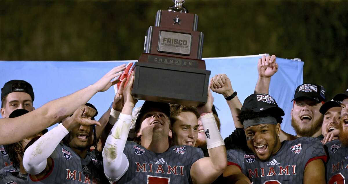 Miami (Ohio) quarterback Brett Gabbert holds up the championship trophy after the team's 27-14 win over North Texas in the Frisco Football Classic NCAA college football game in Frisco, Texas, Thursday, Dec. 23, 2021. (AP Photo/Matt Strasen)
