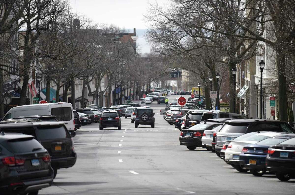 Traffic passes down Greenwich Avenue in Greenwich, Conn.