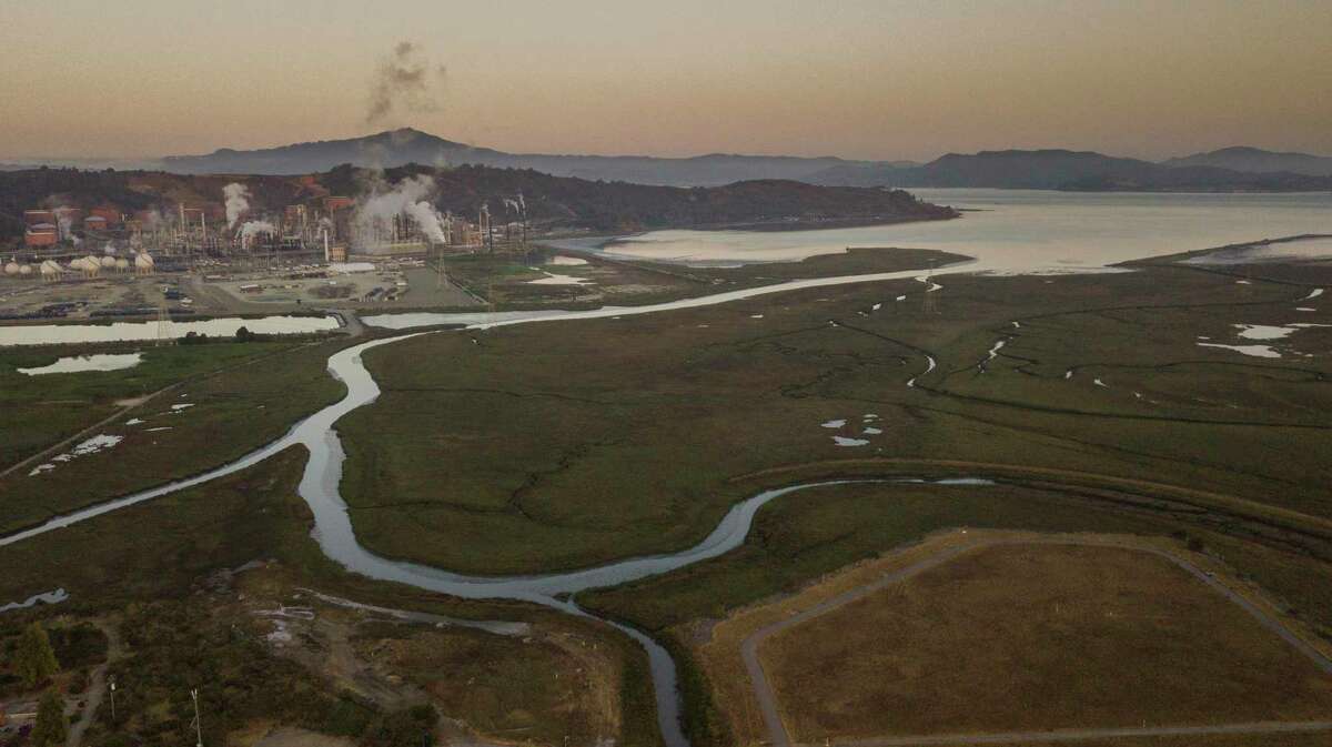Rising sea levels pose an environmental threat to Richmond’s shoreline, which is dotted with heavy industry, including the Chevron oil refinery.