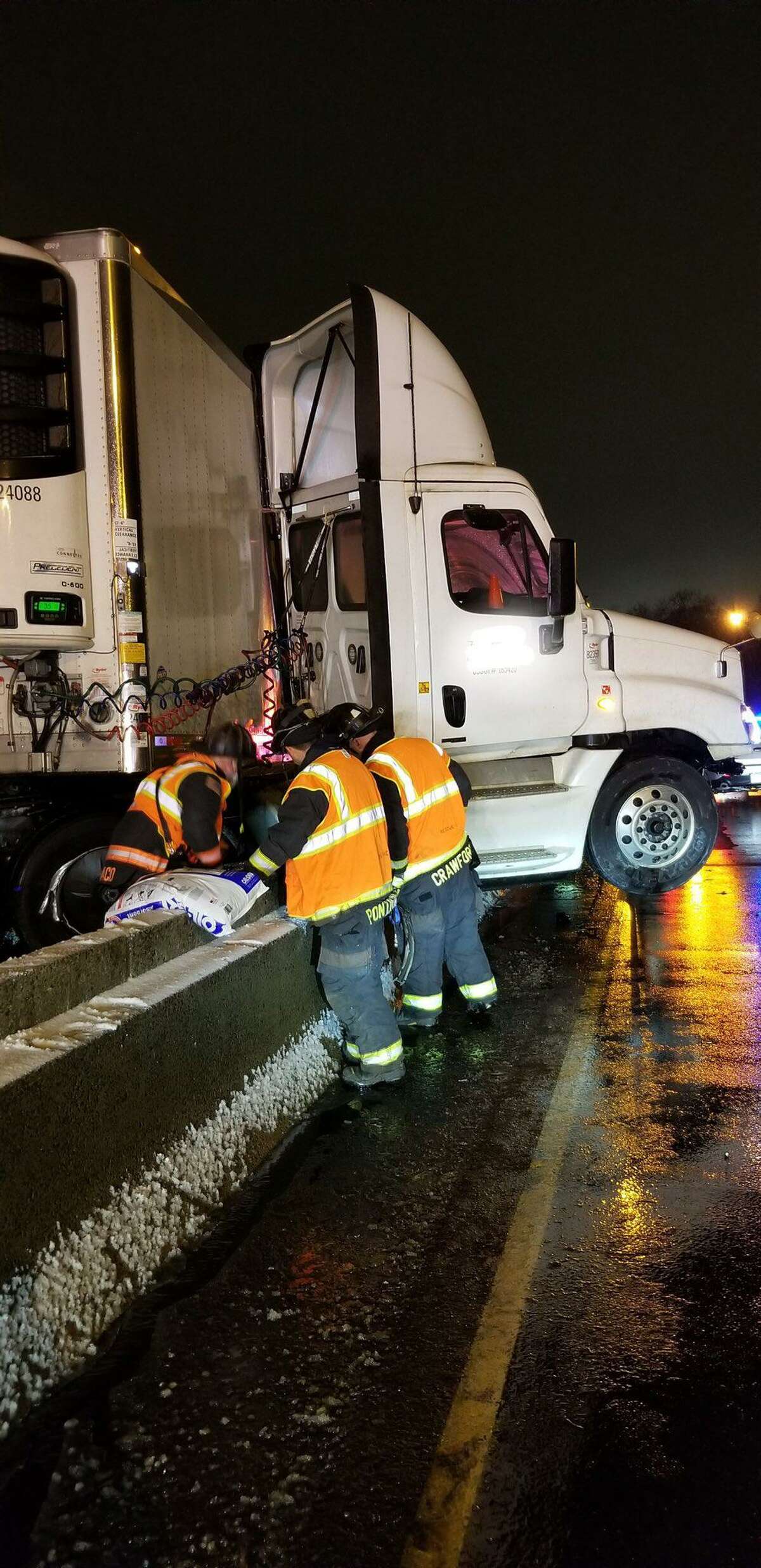 Fire crews from Westport at the scene of a jackknifed tractor-trailer on I-95 in Norwalk, Conn., on Friday, Dec. 24, 2021.