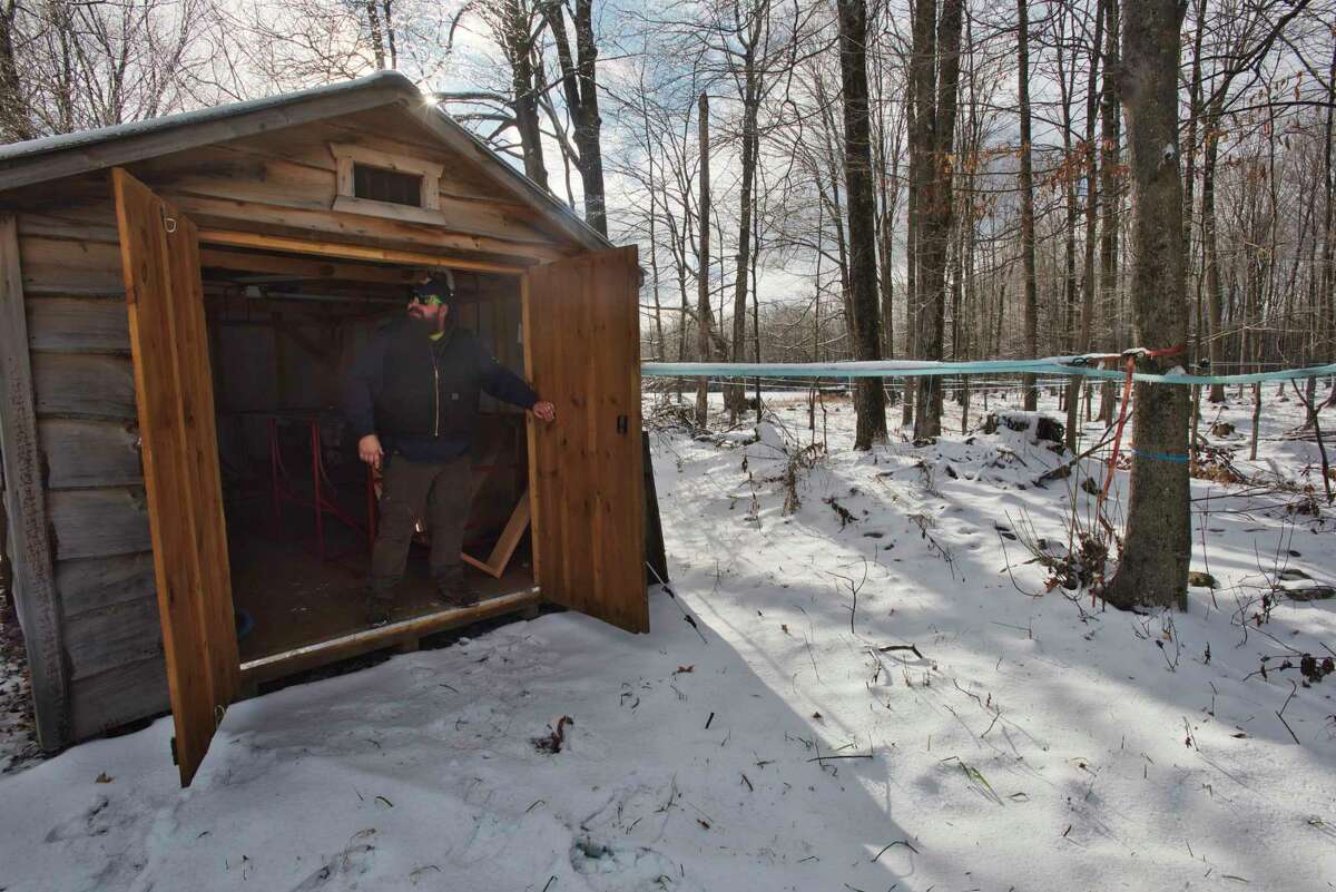 Ryan Veitch, care taker of property at Twin Leaf Farms, stands just inside a sap shed on Monday, Dec. 20, 2021, in Greenfield Center, N.Y. The shed is a collection point where the sap comes in from the lines coming from the maple tress. Owners of the maple farm, Kevin and Claudia Bright, have plans to use some of the land on the farm to get involved in the cannabis market.