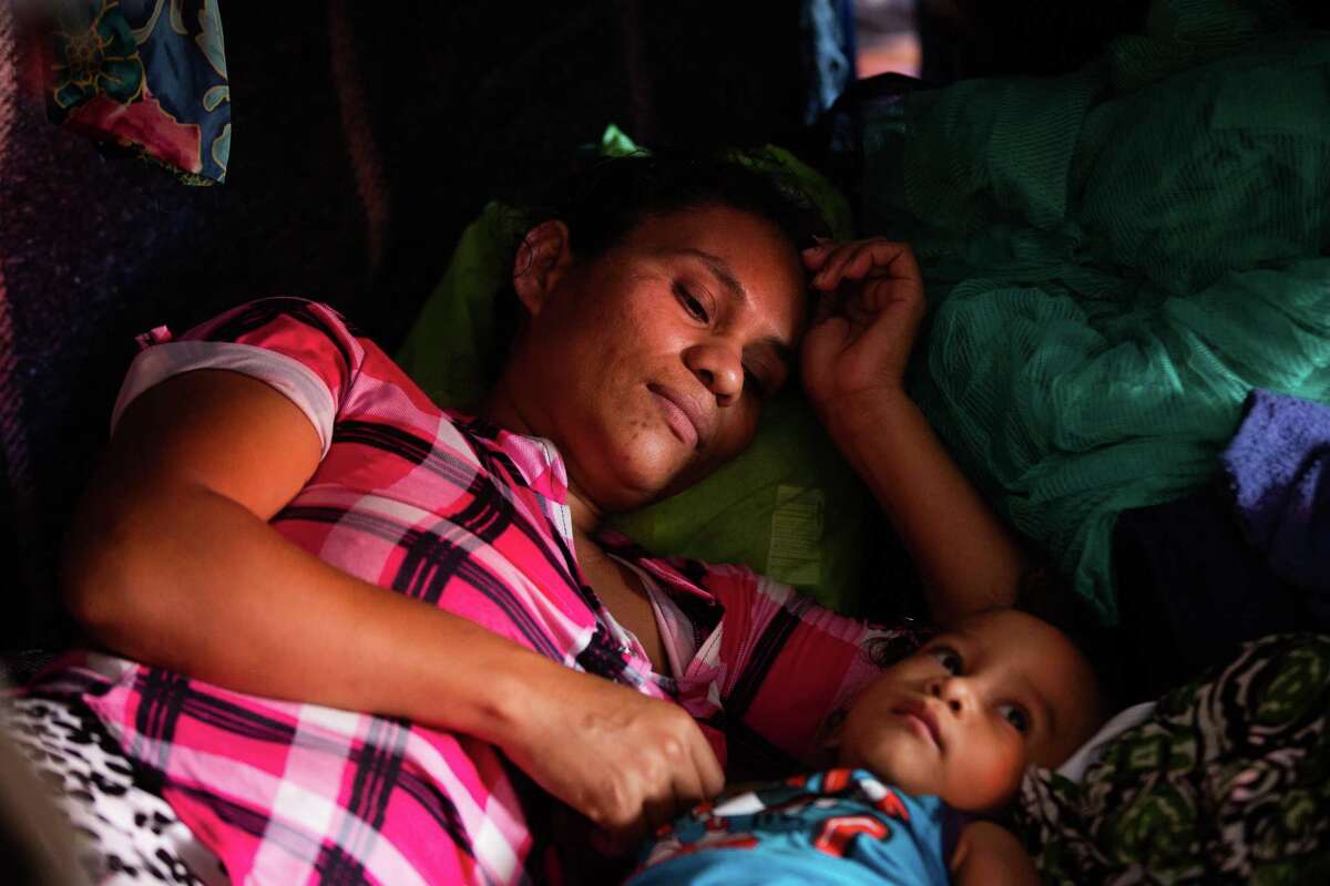 Fany Sirei, 38, from Honduras rests next to her 15-month-old child Junior Yair at a shelter, Friday, Sept. 17, 2021, in Ciudad Acuña.