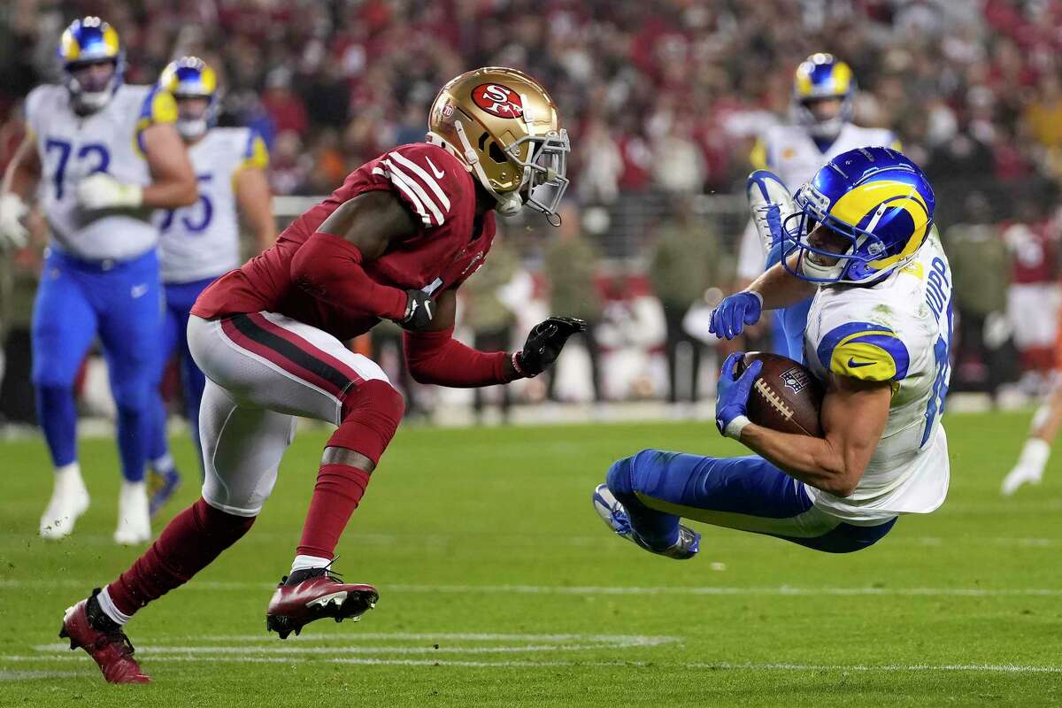 Los Angeles Rams wide receiver Cooper Kupp, right, is tackled in front of San Francisco 49ers cornerback Emmanuel Moseley during the second half of an NFL football game in Santa Clara, Calif., Monday, Nov. 15, 2021. (AP Photo/Tony Avelar)