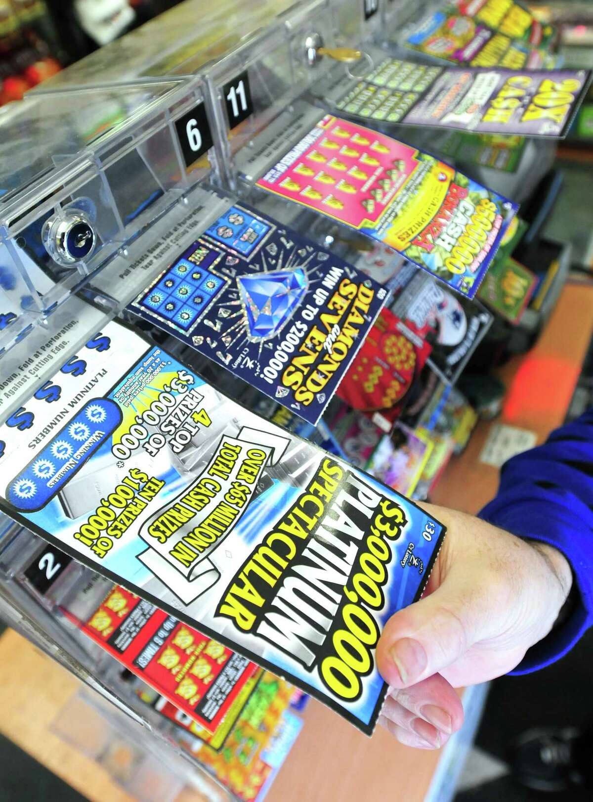 Instant lottery tickets for sale are photographed at Gerry's Shell Foodmart in New Haven in January 2011. Since Monday, 30 people have claimed a prize of $10,000 or more after buying lottery tickets from retailers across the state.