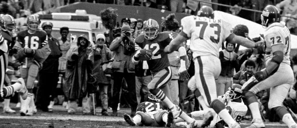 San Francisco 49ers vs. New York Giants at Candlestick Park Sunday, January 3. 1982. 49ers beat Giants 38-24 for Division Playoff. San Francisco Defensive Back Ronnie Lott (42) makes runback after catching interception. (AP Photo/Al Golub)