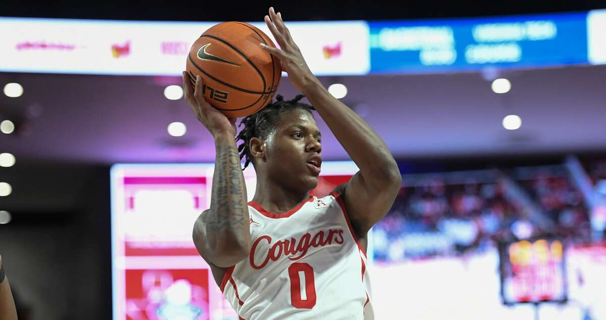 Houston guard Marcus Sasser (0) passes the ball against Texas State during the first half of an NCAA college basketball game Wednesday, Dec. 22, 2021, in Houston. (AP Photo/Justin Rex)