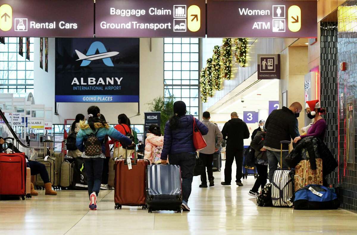 Christmas Day travelers make their way through Albany International Airport on Saturday, Dec. 25, 2021, in Colonie, N.Y. Travel was disrupted on New Year's Day due to snowy weather in Chicago.