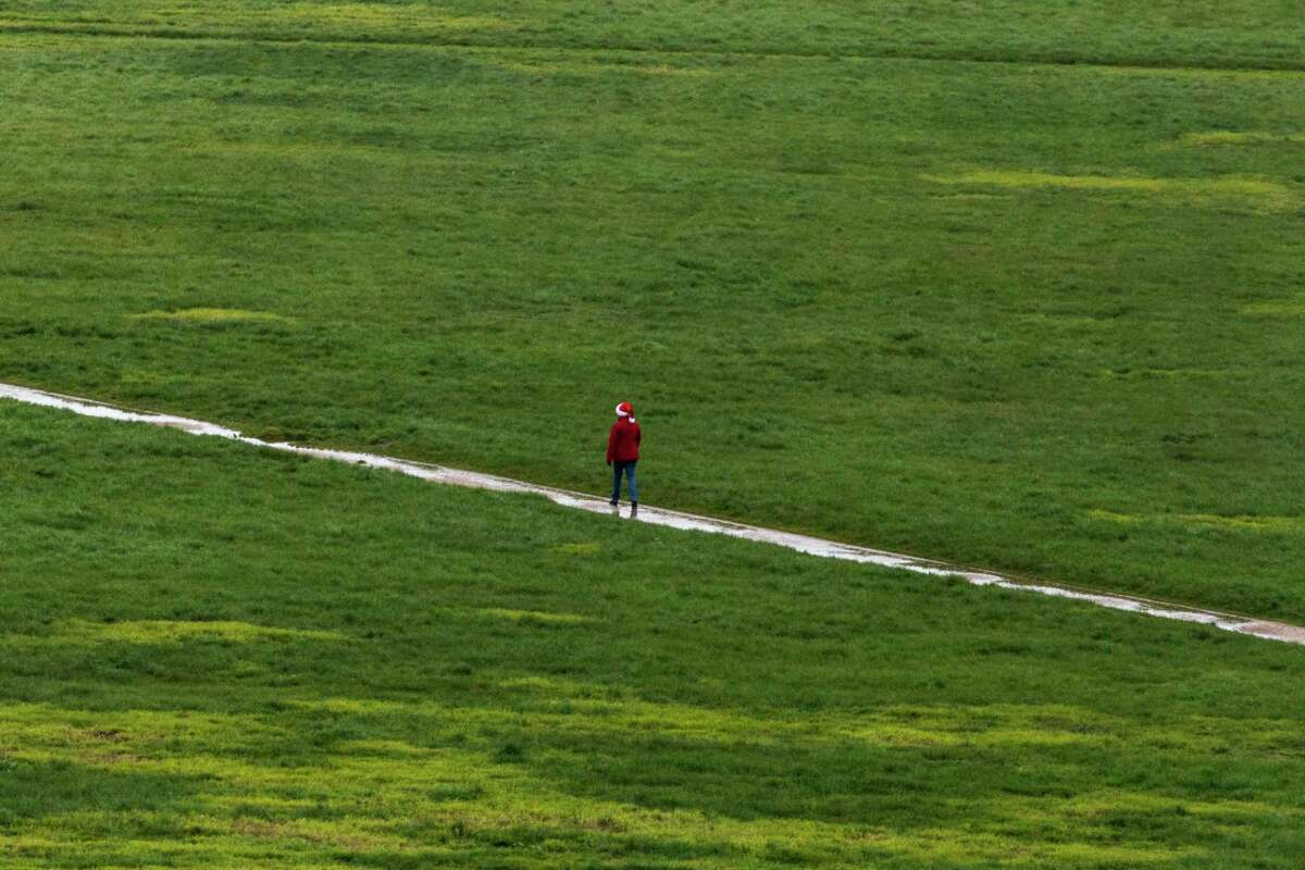 A pedestrian walks through a water-clogged path on San Francisco’s Crissy Field on Christmas Day.
