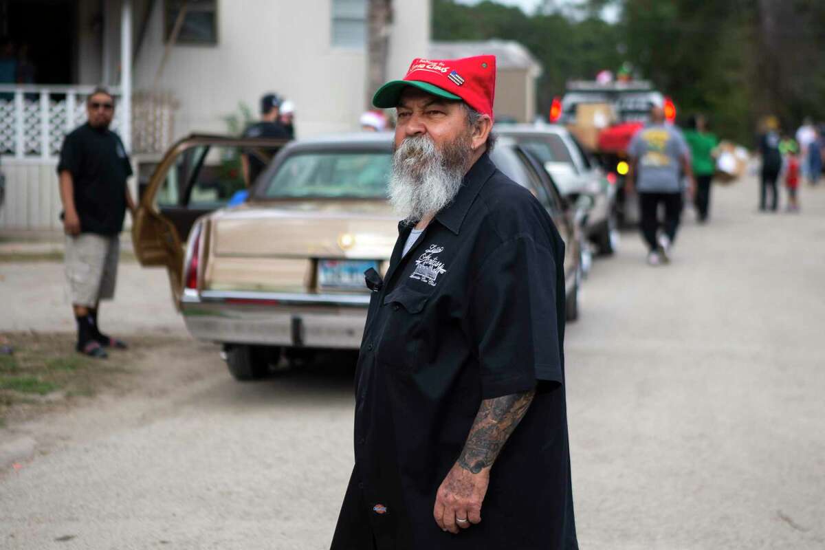 Sotero “Shorty” Villarreal, Sr., leads the Latin Fantasy Lowrider Car Club as they gave out toys and goodie bags in the Aldine area Saturday, Dec. 25, 2021 in Houston. Latin Fantasy’s tradition began 30 years ago with a single truckload of toys and two lowrider cars cruising through low-income neighborhoods of North Houston. Latin Fantasy Lowrider Car Club now consists of over 25 active members and their families who will be distributing over 7,000 toys and goodie bags this year.