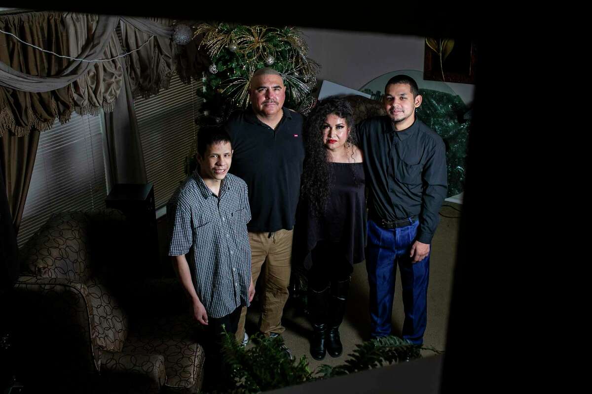 From left: John King, Art Molina, Lorena Rodriguez, and Abraham Garcia are pictured at their South Side home last week. King and Garcia joined the family under legal guardianships that Bexar County officials say are badly needed for adults with intellectual disabilities.
