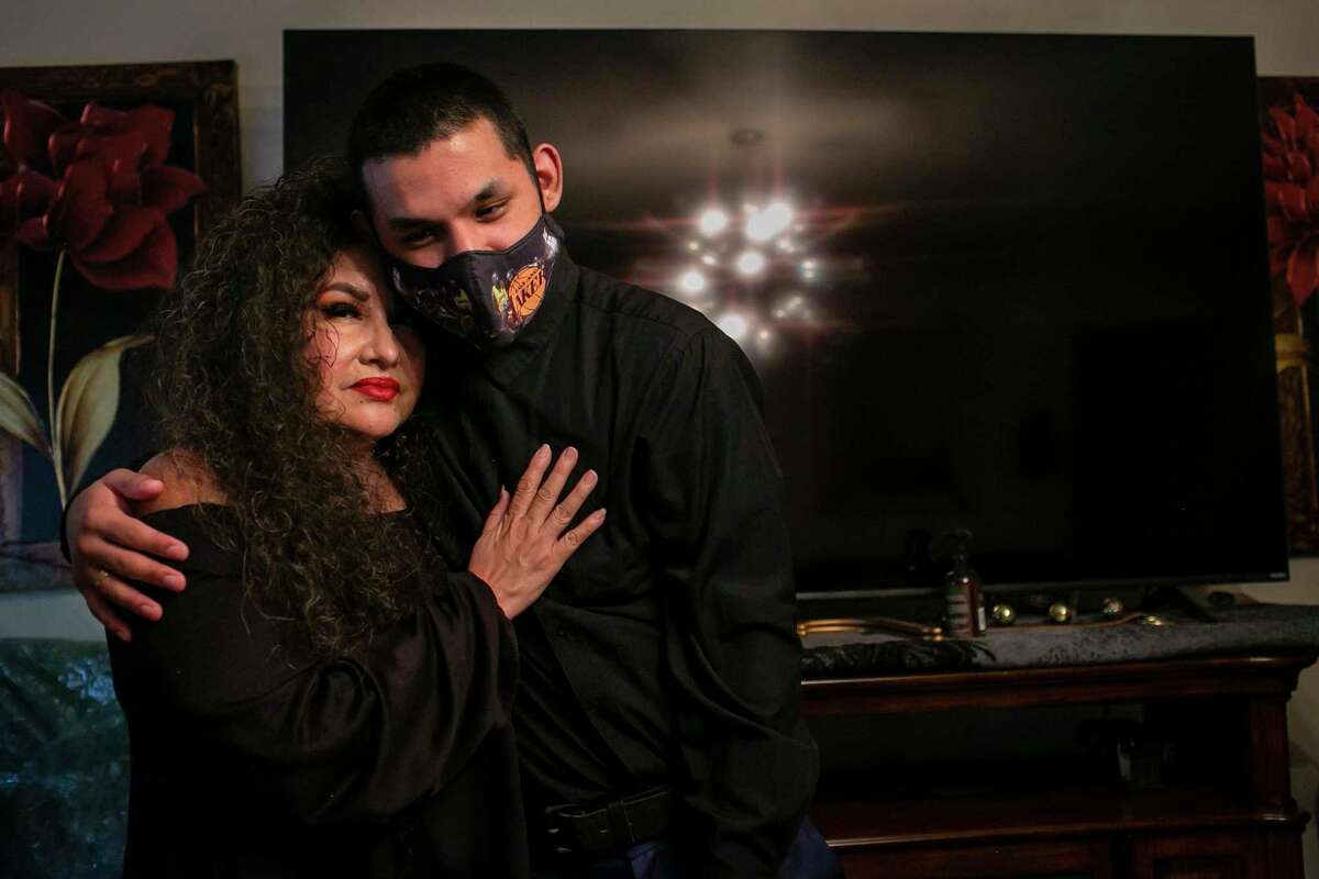Lorena Rodriguez embraces her adopted son Abraham Garcia, 21, at their South Side home. Abraham had been in the foster care system since 2005 and experienced neglect and abuse. Now 21, he has found his “forever home.”
