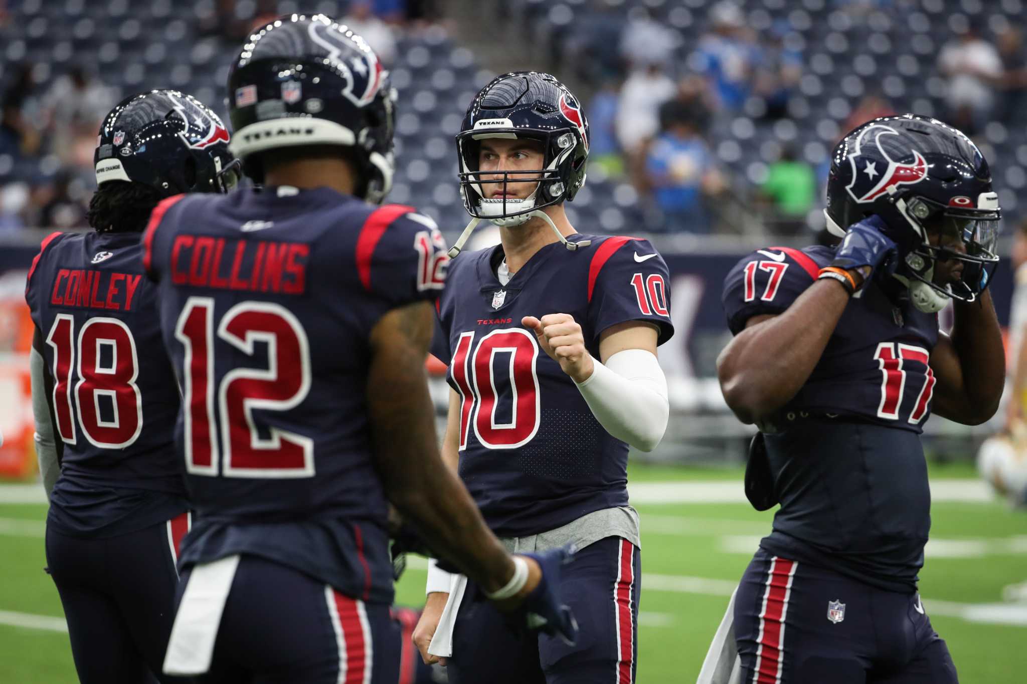 Los Angeles Chargers' Josh Palmer (5) is tackled by Houston Texans' Tremon  Smith (24) during the second half of an NFL football game Sunday, Dec. 26,  2021, in Houston. The Texans won