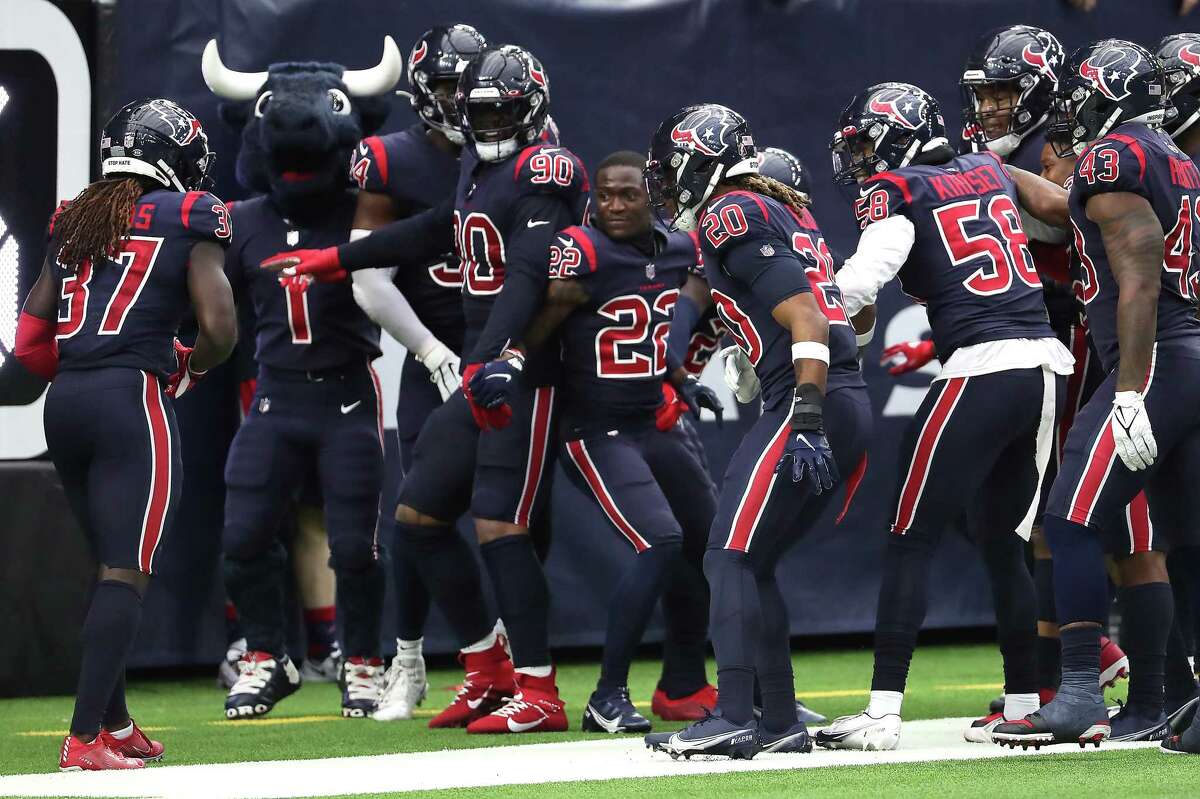 Houston Texans cornerback Tavierre Thomas (37) celebrate with his teammate after returning an interception of a pass by Los Angeles Chargers quarterback Justin Herbert for a touchdown during the fourth quarter of an NFL football game Sunday, Dec. 26, 2021 in Houston.