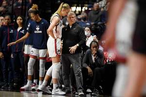 UConn coach Geno Auriemma, center right, talks with Dorka Juhasz during a recent game. UConn’s game against Marquette on Wednesday has been canceled due to COVID-19 issues in the Marquette program.
