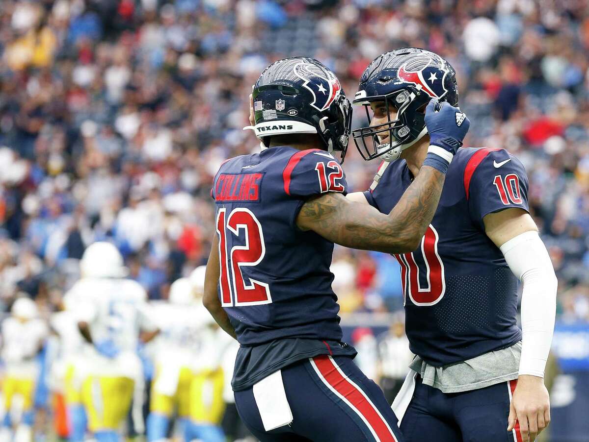 Houston Texans wide receiver Nico Collins (12) celebrates with quarterback Davis Mills (10) after scoring a 13-yard receiving touchdown against the Los Angeles Chargers during the fourth quarter of an NFL game at NRG Stadium on Sunday, Dec. 26, 2021, in Houston.