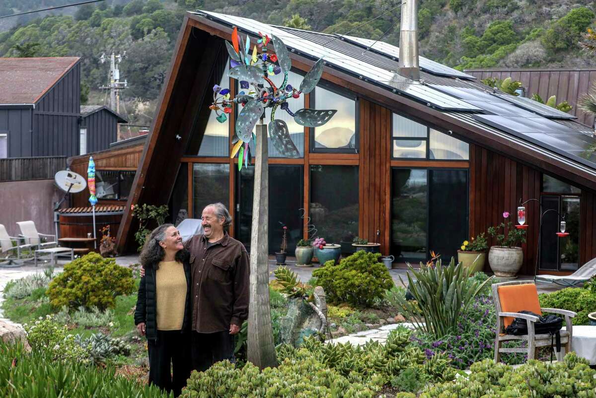 Dan and Teri Fruchtman outside their home in Stinson Beach. The couple has lived in their A-frame coastal home since the late 1980s and have watched the landscape change due to climate change.