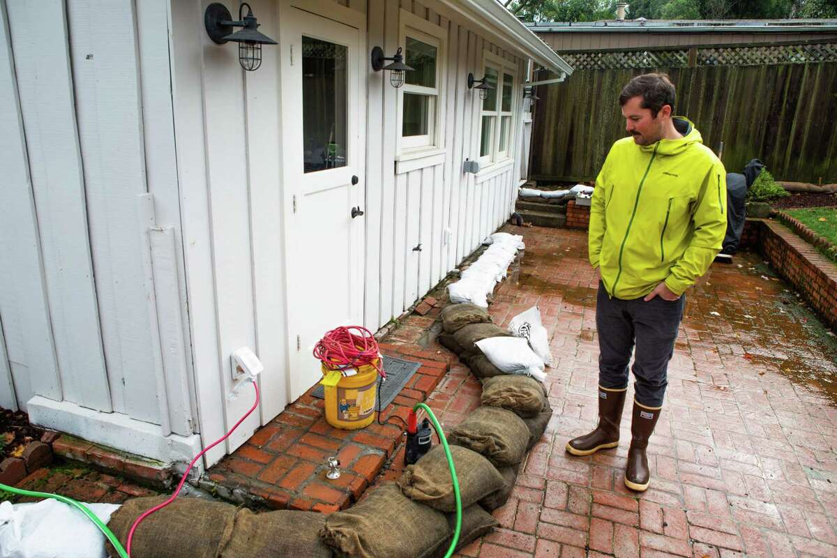Mill Valley fisherman Peter Irving checks on a friend’s house that’s had flooding after the heavy rainfall.