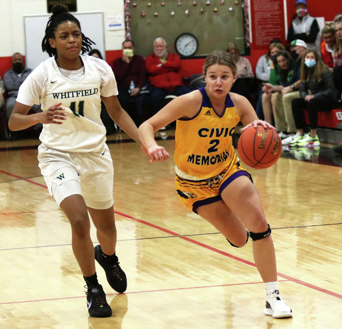 CM's Avari Combes (right) drives past Whitfield's Brooklyn Rhodes during the first half Sunday night in the quarterfinals of the Visitation Christmas Tournament in St. Louis.
